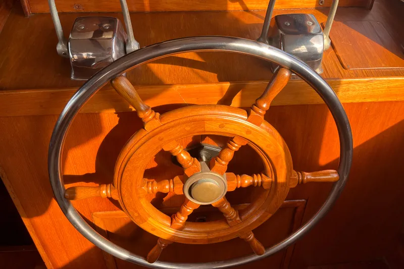 Slide: The Image of Wooden steering wheel of a 1986 Jefferson 42 SE Sundeck Motor Yacht. - 23