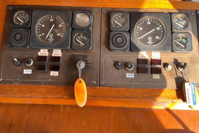 Slide: The Image of Control panel of a 1986 Jefferson 42 SE Sundeck Motor Yacht with gauges and switches. - 24