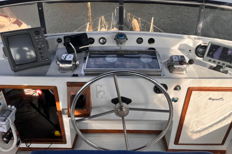 Slide: The Image of Helm of 1986 Jefferson 42 SE Sundeck Motor Yacht with navigation equipment and steering wheel. - 3