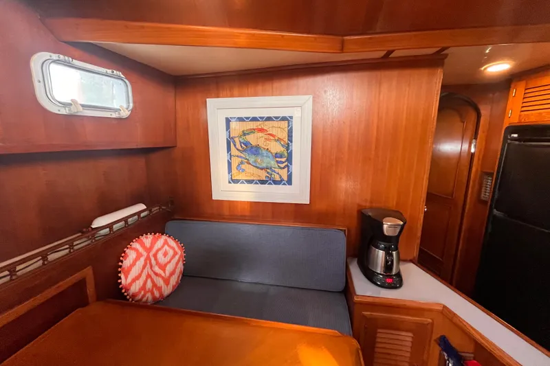 Slide: The Image of Cozy interior of 1986 Jefferson 42 SE Sundeck Motor Yacht with seating and coffee maker. - 30