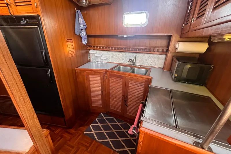 Slide: The Image of 1986 Jefferson 42 SE Sundeck Motor Yacht kitchen with wood cabinetry and modern appliances. - 31