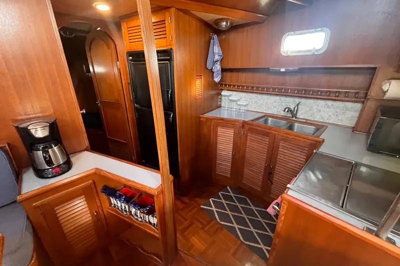 Slide: The Image of Interior of 1986 Jefferson 42 SE Sundeck Motor Yacht kitchen with wood cabinetry. - 32