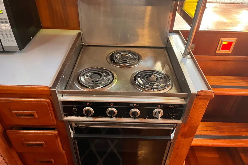 Slide: The Image of Electric stove in the kitchen of a 1986 Jefferson 42 SE Sundeck Motor Yacht. - 36