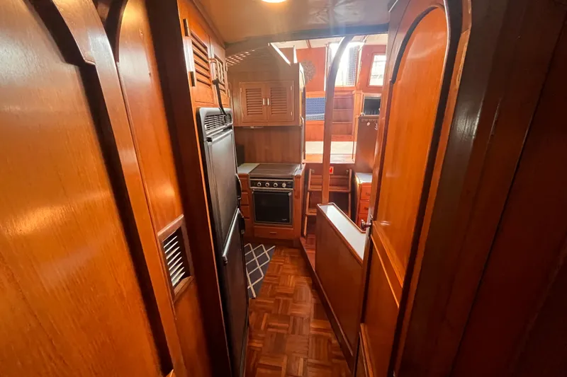 Slide: The Image of 1986 Jefferson 42 SE Sundeck Motor Yacht interior with wood finish and kitchen area. - 38