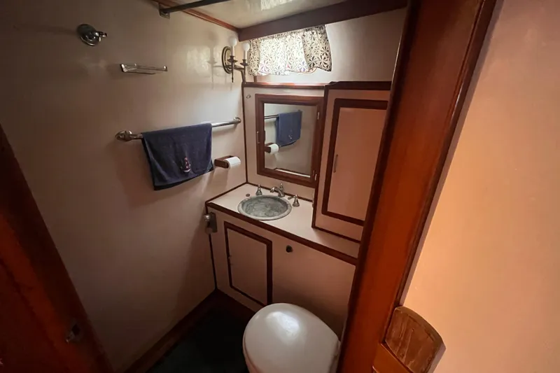 Slide: The Image of Bathroom interior of 1986 Jefferson 42 SE Sundeck Motor Yacht, featuring sink and mirror. - 39
