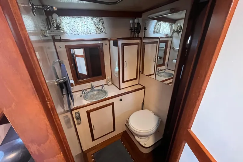 Slide: The Image of Bathroom interior of 1986 Jefferson 42 SE Sundeck Motor Yacht, featuring sink and toilet. - 40