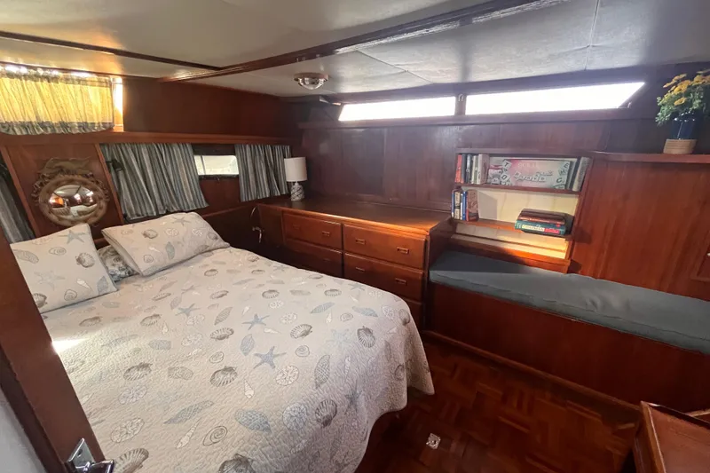 Slide: The Image of Cozy bedroom in 1986 Jefferson 42 SE Sundeck Motor Yacht with wood paneling and nautical decor. - 49