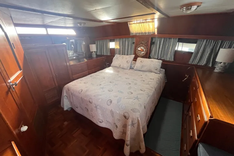 Slide: The Image of Luxurious 1986 Jefferson 42 SE Sundeck Motor Yacht bedroom with elegant wood furnishings. - 50