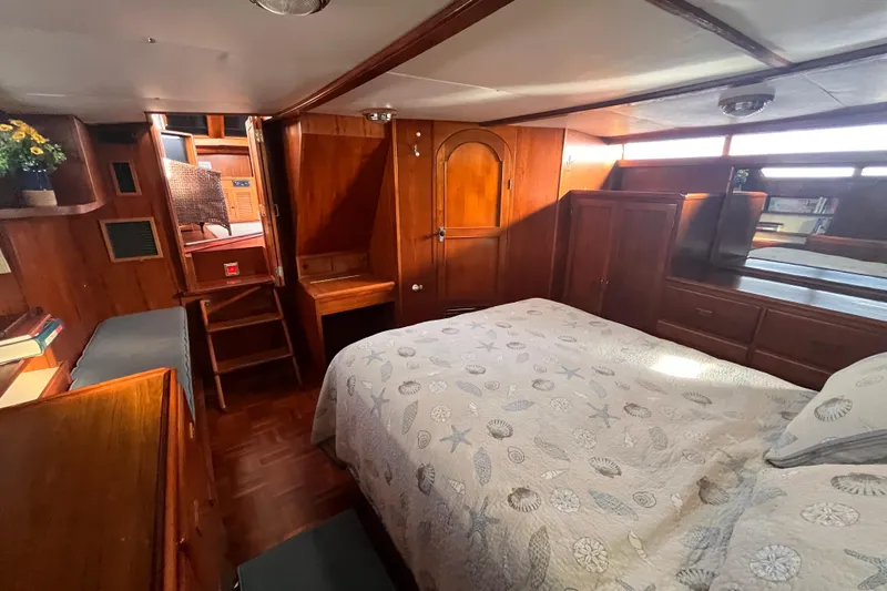 Slide: The Image of Interior of 1986 Jefferson 42 SE Sundeck Motor Yacht with cozy bedroom and wooden furnishings. - 52