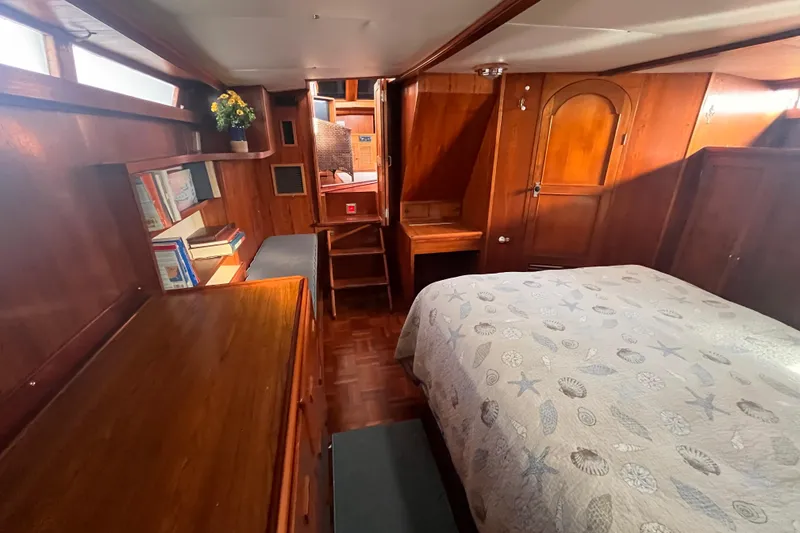 Slide: The Image of 1986 Jefferson 42 SE Sundeck Motor Yacht cabin with wood interior and cozy bed. - 53