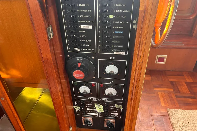 Slide: The Image of Electrical panel on a 1986 Jefferson 42 SE Sundeck Motor Yacht, featuring AC and DC controls. - 54