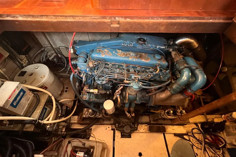 Slide: The Image of Engine room of 1986 Jefferson 42 SE Sundeck Motor Yacht with visible blue engine components. - 62