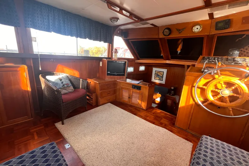 Slide: The Image of Interior of 1986 Jefferson 42 SE Sundeck Motor Yacht with wooden helm and cozy seating. - 63