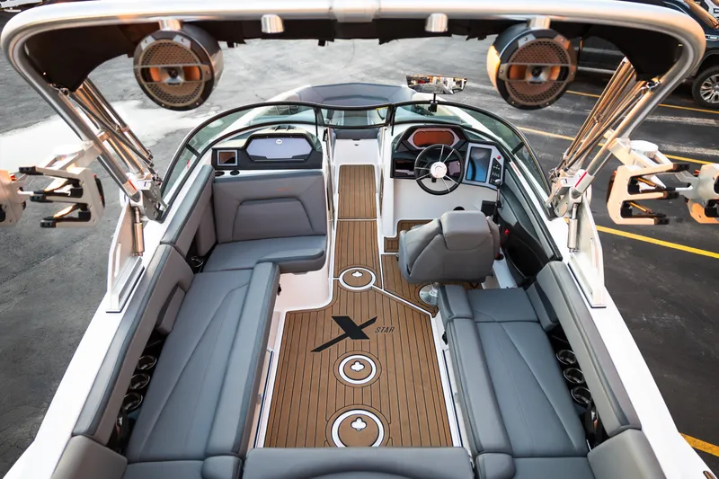 Slide: The Image of 2022 MasterCraft XStar boat interior with sleek seating and advanced dashboard features. - 11