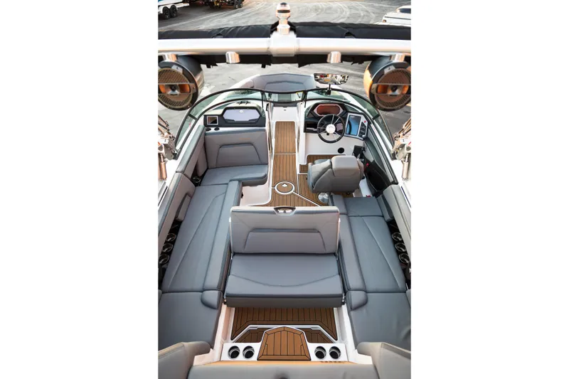 Slide: The Image of 2022 MasterCraft XStar boat interior with sleek design, luxurious seating, and modern dashboard. - 14