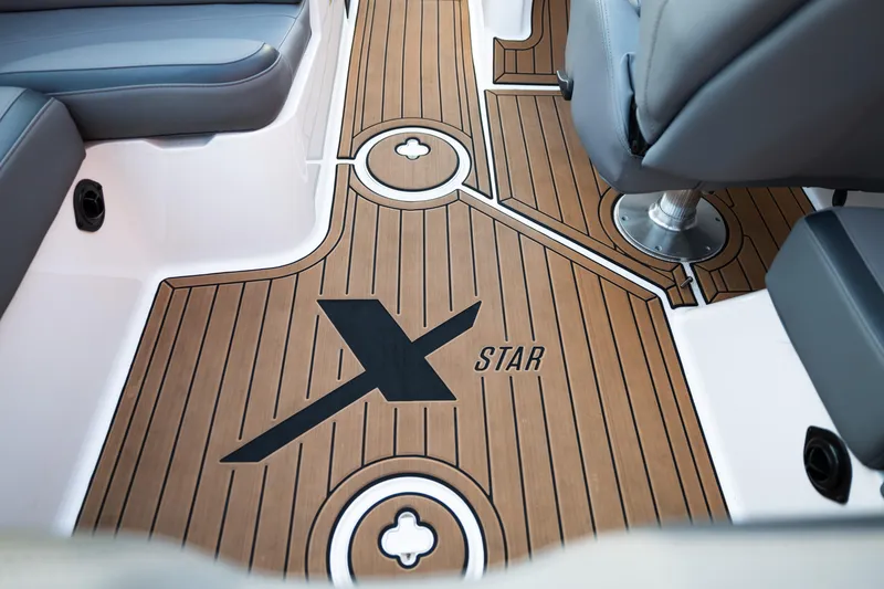 Slide: The Image of 2022 MasterCraft XStar boat interior with sleek wood flooring and modern seating. - 15