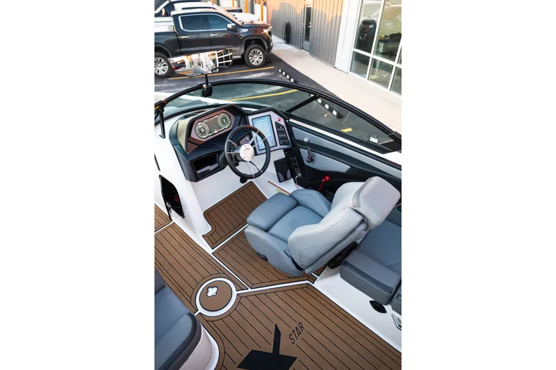 Slide: The Image of 2022 MasterCraft XStar boat interior with modern dashboard and luxurious seating. - 16
