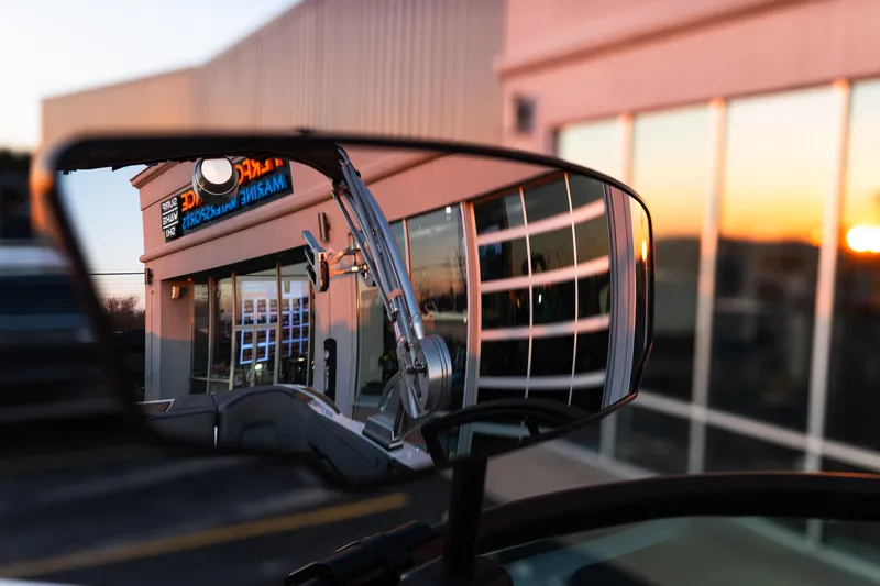 Slide: The Image of Reflection of a 2022 MasterCraft XStar in a side mirror at sunset. - 22