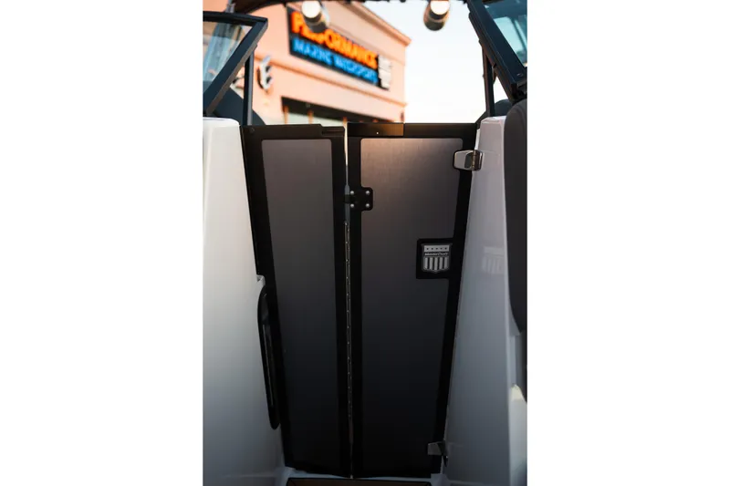 Slide: The Image of 2022 MasterCraft XStar boat interior door with sleek design and branding. - 23