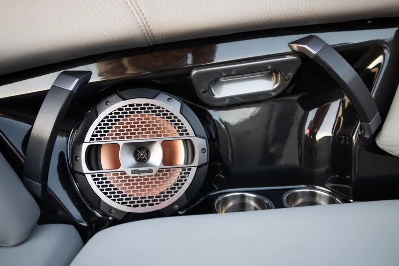Slide: The Image of 2022 MasterCraft XStar boat interior with Klipsch speaker and cup holders. - 24