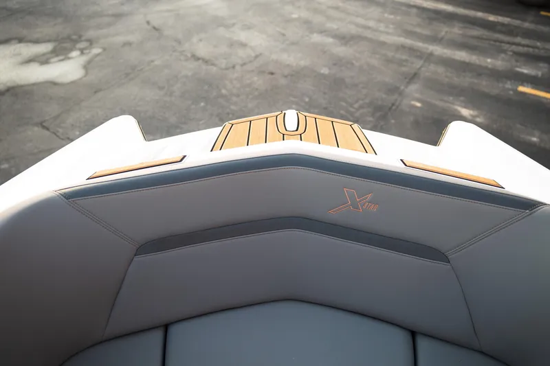 Slide: The Image of 2022 MasterCraft XStar boat interior with sleek design and logo detail. - 25