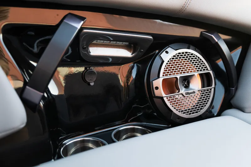 Slide: The Image of 2022 MasterCraft XStar interior speaker and cup holders detail. - 26