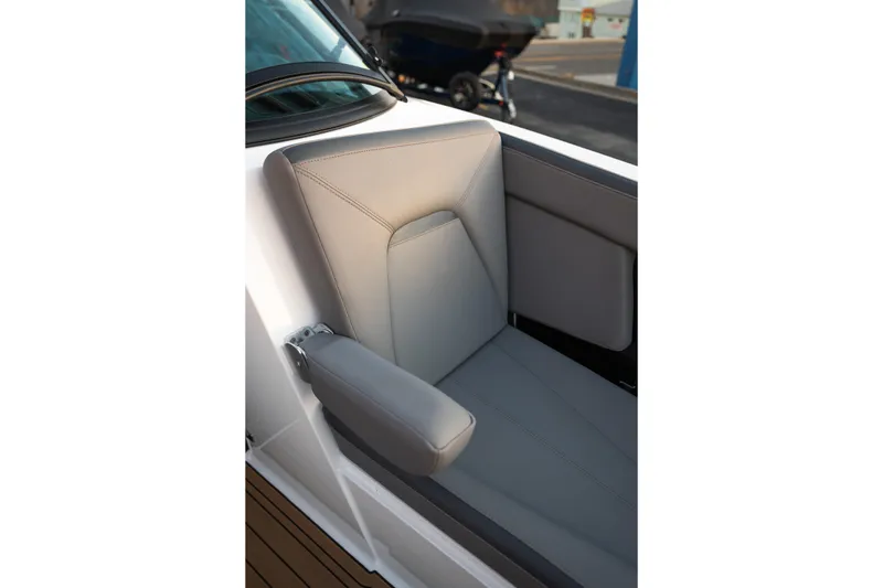 Slide: The Image of 2022 MasterCraft XStar boat seat with sleek gray upholstery and armrest. - 27