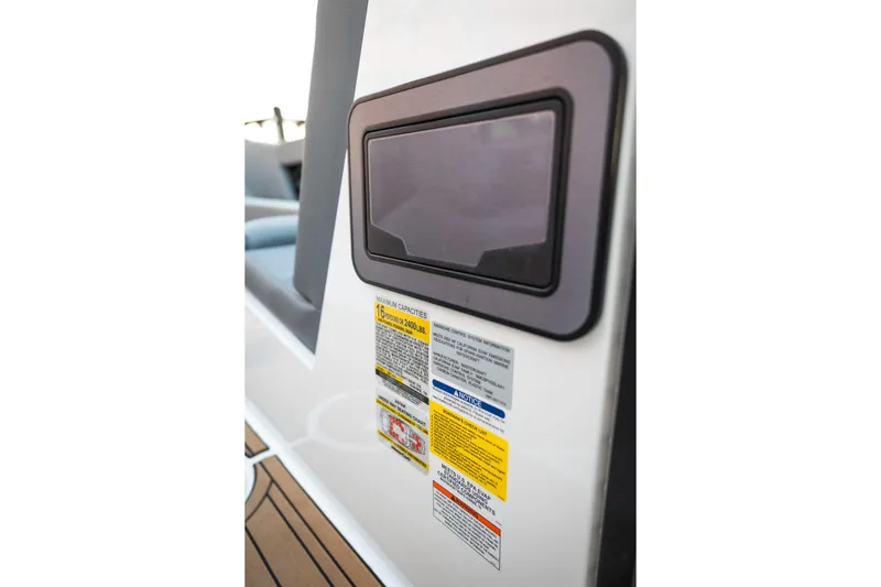 Slide: The Image of 2022 MasterCraft XStar boat warning labels and control panel close-up. - 30