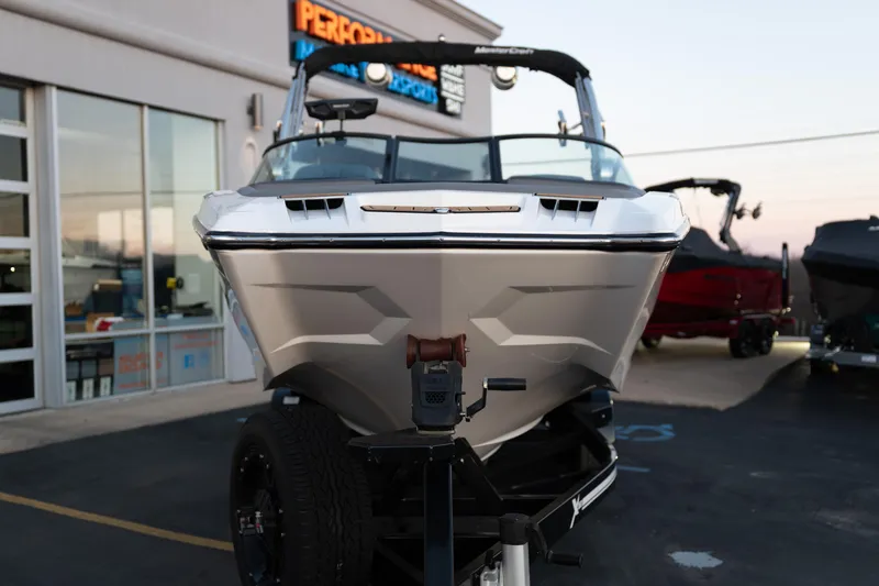 Slide: The Image of 2022 MasterCraft XStar boat on trailer outside dealership at sunset. - 35