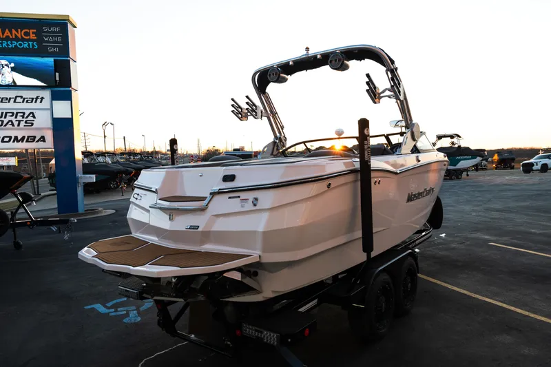 Slide: The Image of 2022 MasterCraft XStar boat on trailer at dealership during sunset. - 9