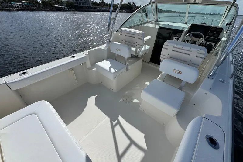Slide: The Image of 2007 Pursuit OS 255 Offshore boat interior with seating and steering console. - 10
