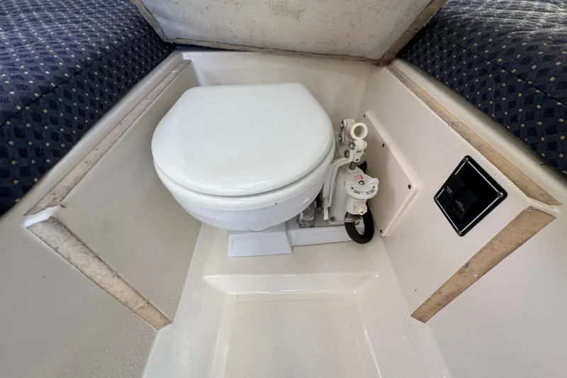 Slide: The Image of 2007 Pursuit OS 255 Offshore boat interior with marine toilet and seating. - 13