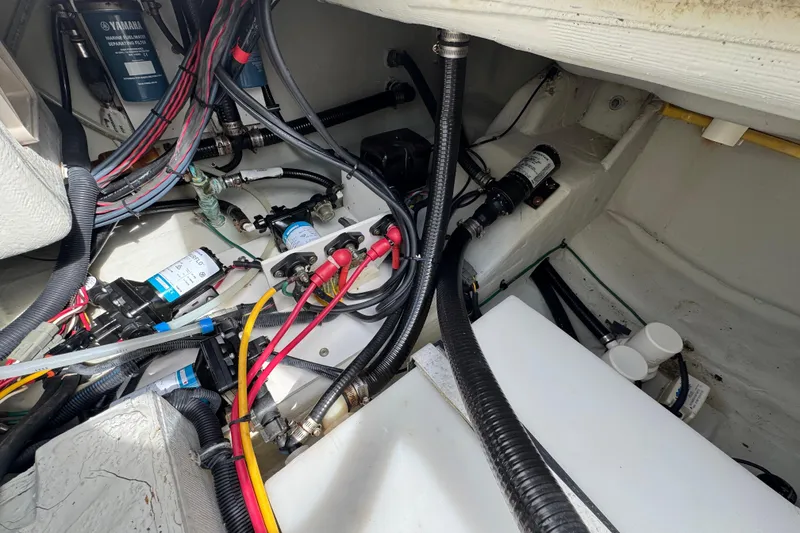 Slide: The Image of 2007 Pursuit OS 255 Offshore boat wiring and engine components in the compartment. - 16