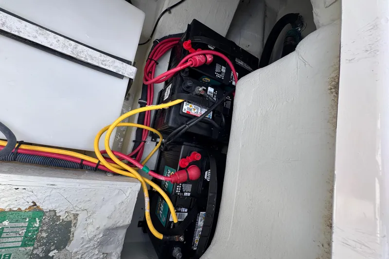Slide: The Image of Battery compartment of a 2007 Pursuit OS 255 Offshore boat with cables. - 17