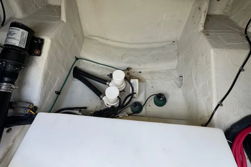 Slide: The Image of 2007 Pursuit OS 255 Offshore boat interior showing wiring and components. - 18