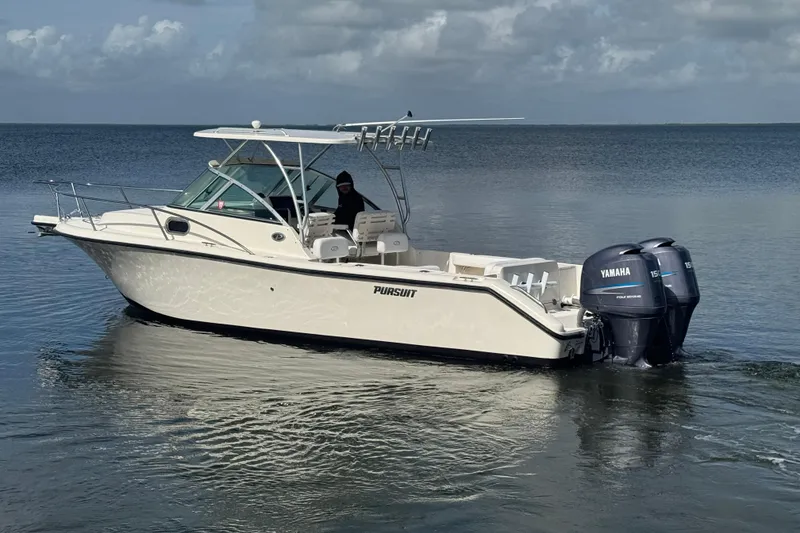 Slide: The Image of 2007 Pursuit OS 255 Offshore boat with twin Yamaha engines on calm water. - 3