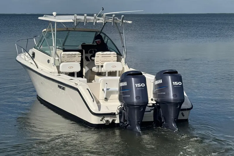 Slide: The Image of 2007 Pursuit OS 255 Offshore boat with dual Yamaha 150 engines on calm water. - 4