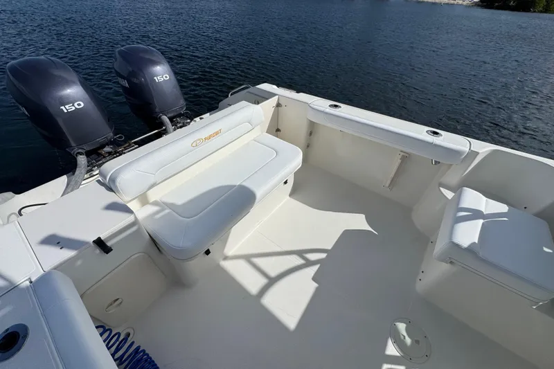 Slide: The Image of 2007 Pursuit OS 255 Offshore boat with twin 150 engines on a calm lake. - 9