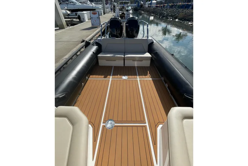 Slide: The Image of 2024 Protector 330 Targa boat interior with teak flooring and twin 400 HP engines. - 13