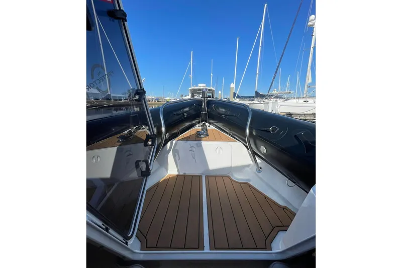 Slide: The Image of 2024 Protector 330 Targa boat interior with teak flooring and sleek design. - 14