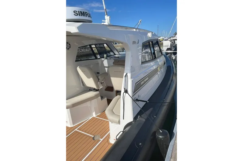 Slide: The Image of 2024 Protector 330 Targa boat with twin 400 HP engines, docked, featuring sleek design. - 16