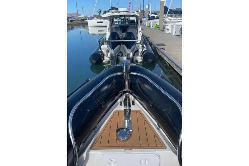 Slide: The Image of 2024 Protector 330 Targa boat with twin 400 HP engines docked at marina. - 18