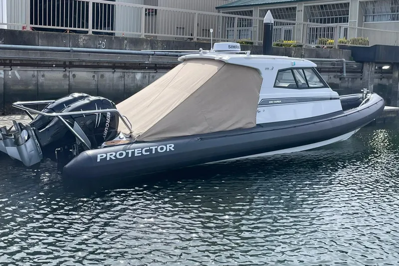 Slide: The Image of 2024 Protector 330 Targa boat with twin 400 HP engines docked in marina. - 24