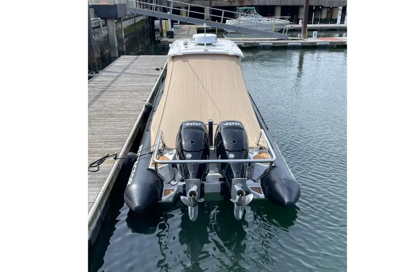 Slide: The Image of 2024 Protector 330 Targa boat with twin 400 HP engines docked at marina. - 25