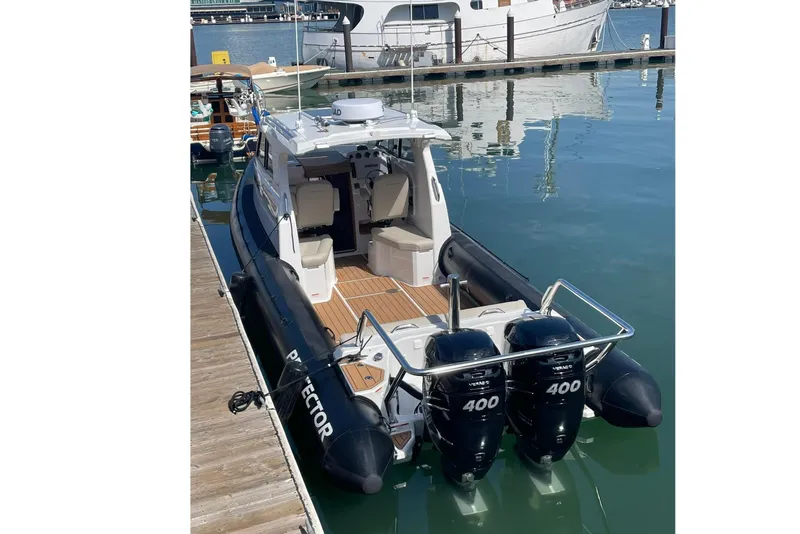 Slide: The Image of 2024 Protector 330 Targa boat with 400 HP engines docked. - 6