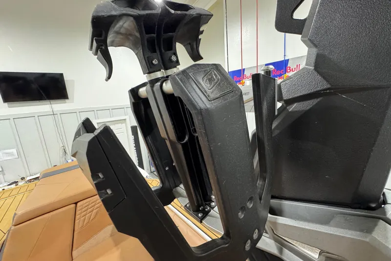 Slide: The Image of 2023 Nautique Super Air Nautique S25 interior with tan seating and teak-style flooring. - 16