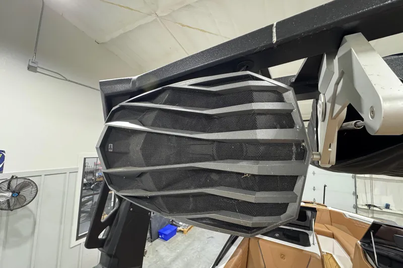 Slide: The Image of 2023 Nautique Super Air Nautique S25 interior with tan leather seating and teak flooring. - 17