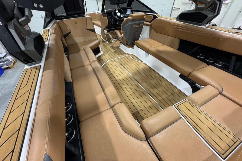 Slide: The Image of 2023 Nautique Super Air Nautique S25 boat on trailer in showroom. - 7