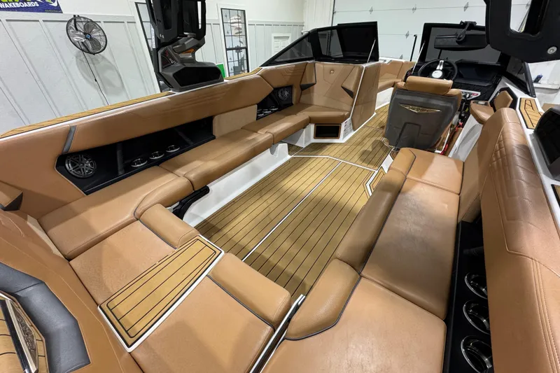 Slide: The Image of 2023 Nautique Super Air Nautique S25 boat on trailer in showroom. - 8