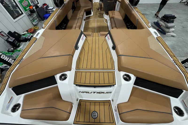 Slide: The Image of 2023 Nautique Super Air Nautique S25 boat stern with exhaust and propeller details. - 9